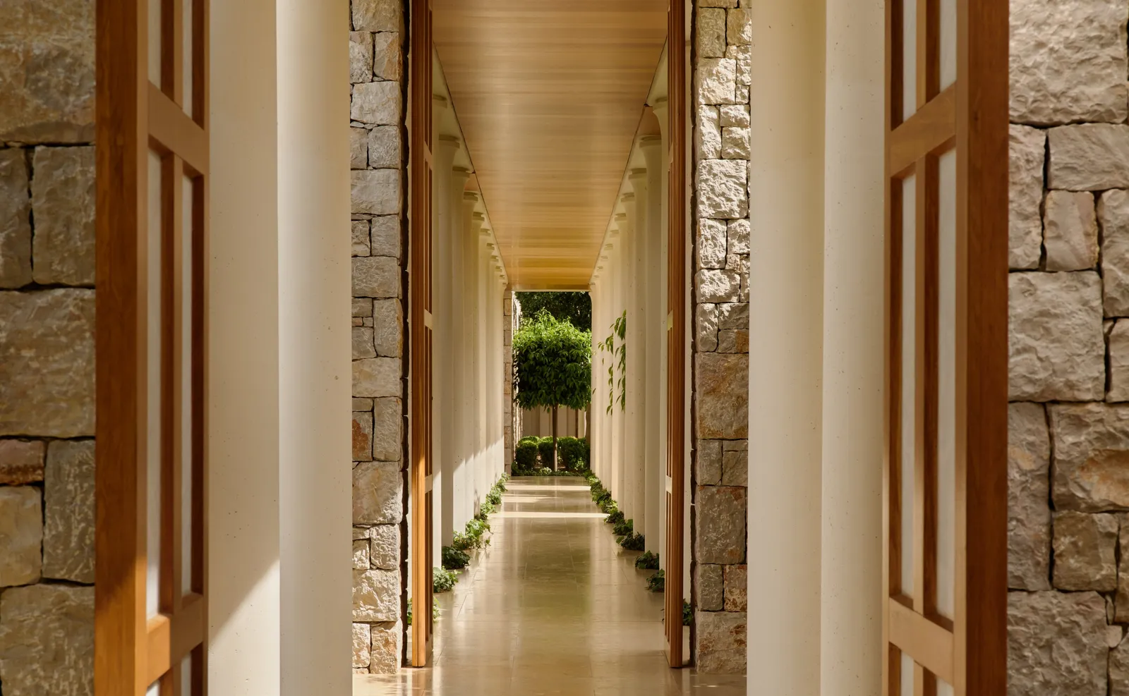The spa’s walkway: dry-stone walls, slatted wooden doors and a rill of water leading to a tree at the far end.