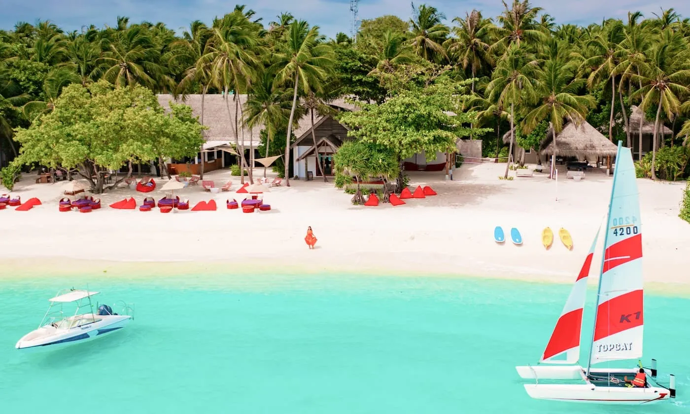 East Beach Club beach and a sailing boat