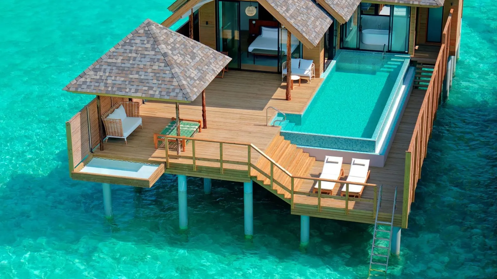 A Deluxe Water Pool Villa’s deck from above, with its long pool and gazebo.