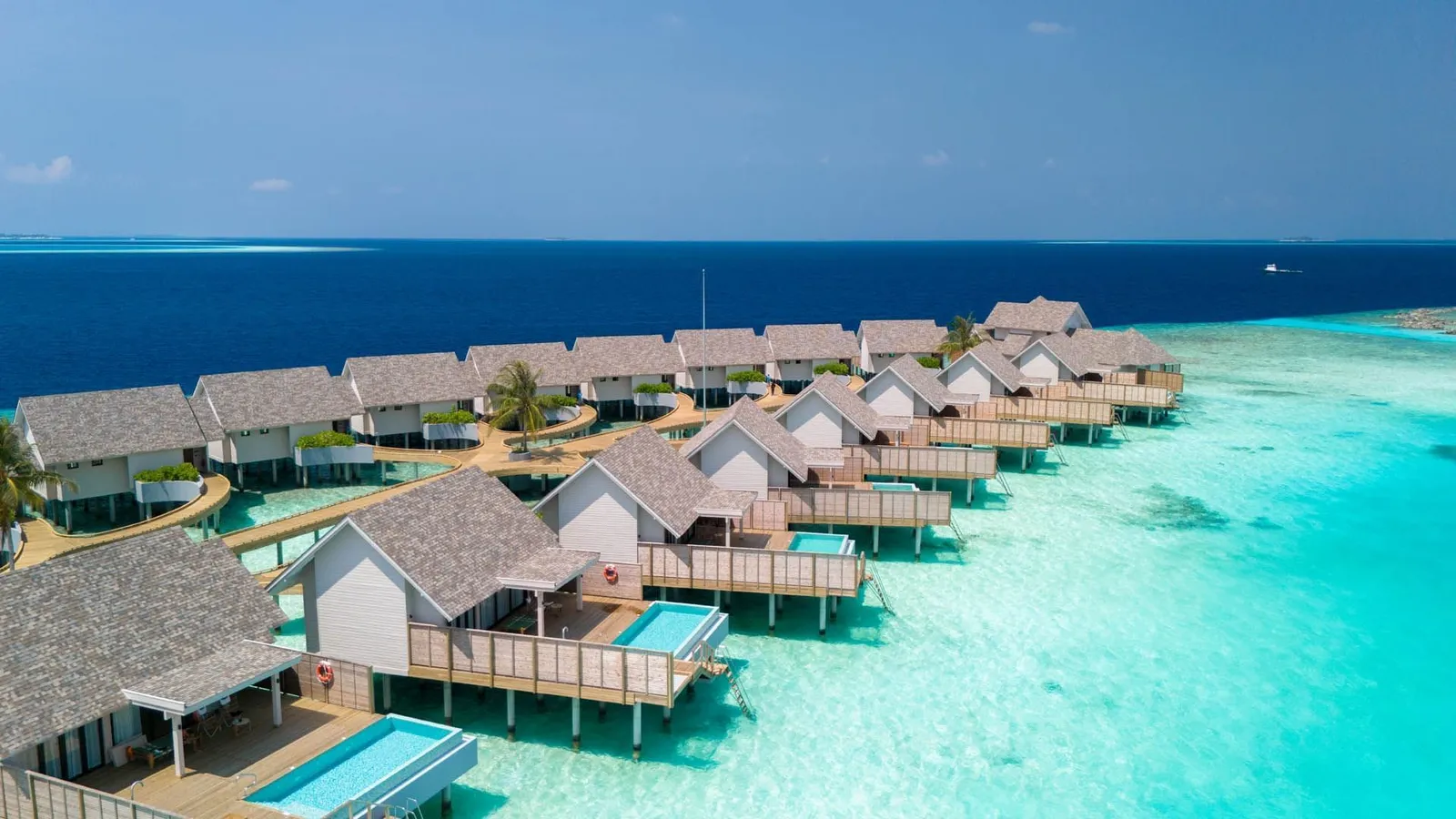 The row of Water Pool Villas on stilts, each with a pool on its deck.