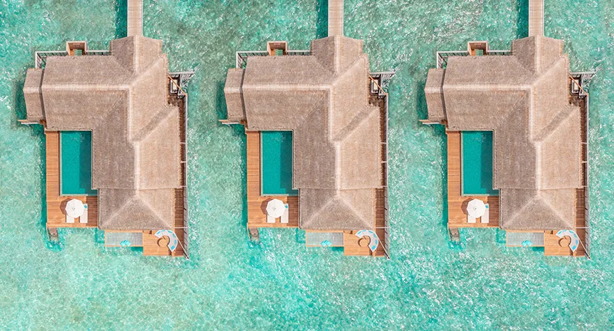 3 water villas from above, each with a pool on its deck