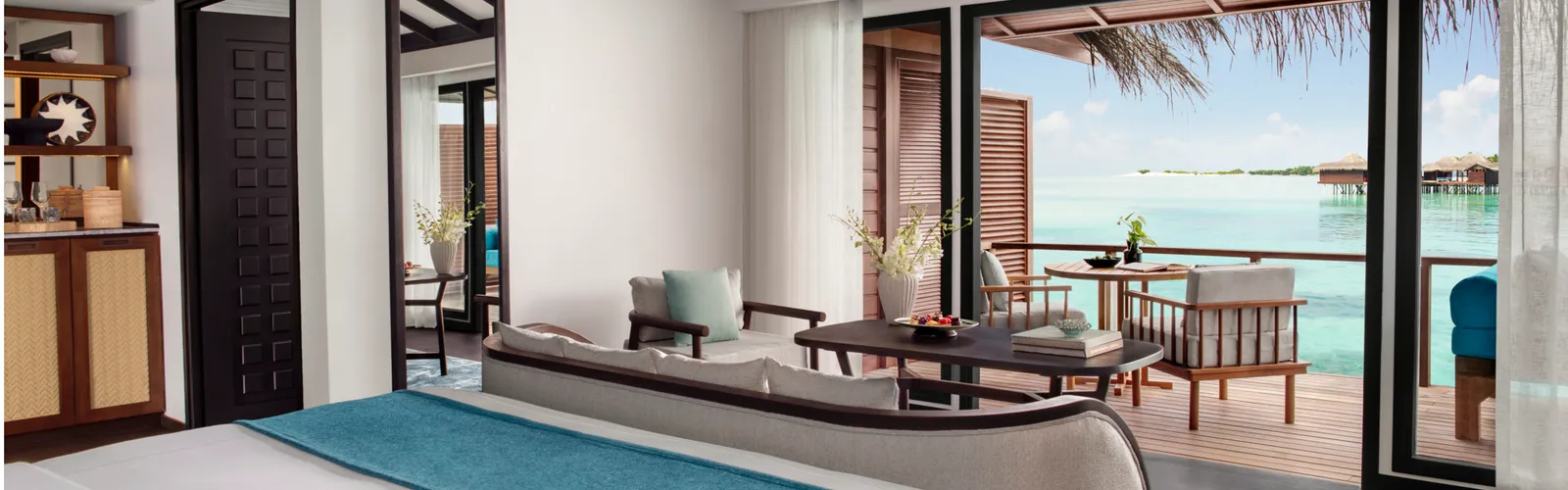 La camera della Over Water Villa, il letto e le vetrate verso l’esterno