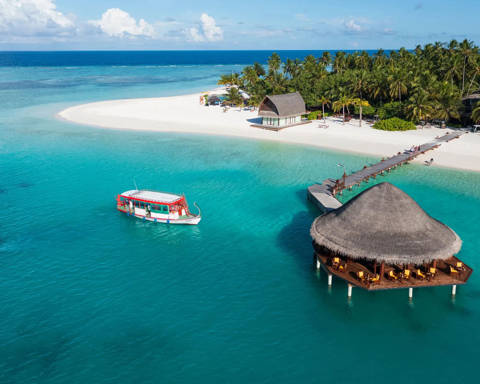 The ferry dhoni in the lagoon off the restaurant on the water and the island’s jetty.