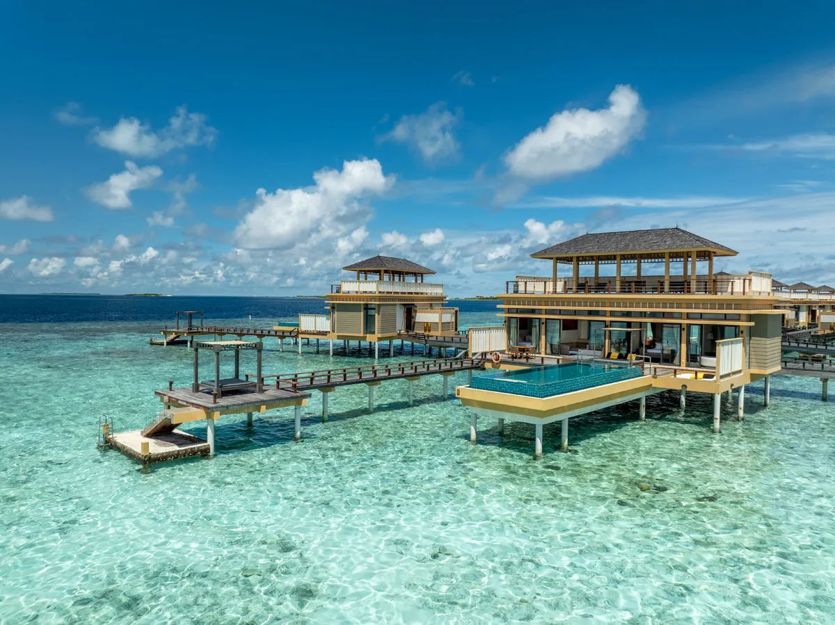 The Deluxe InOcean Two Bedroom Pool Villa over the lagoon, with its long pool and steps into the water.