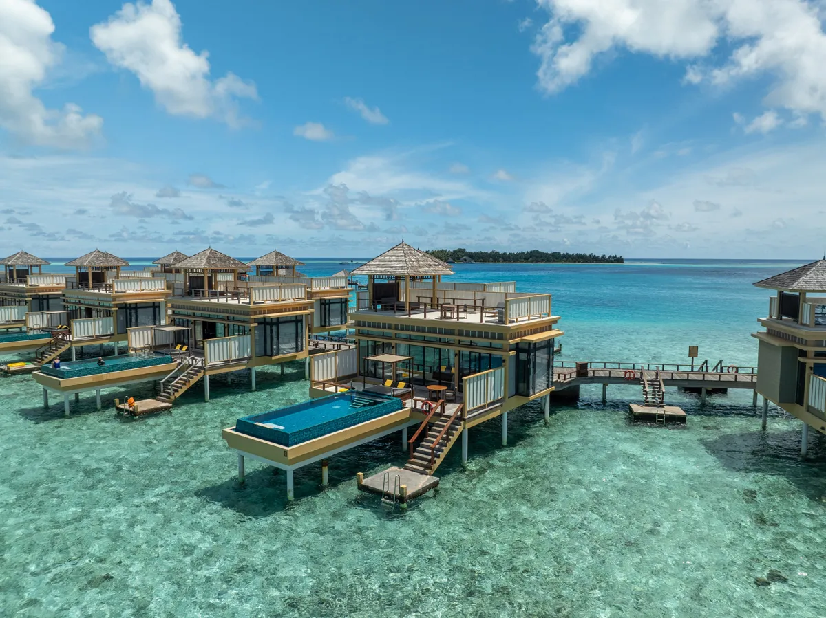 2-storey InOcean Pool Villas over the clear lagoon, each with an infinity pool on its deck.