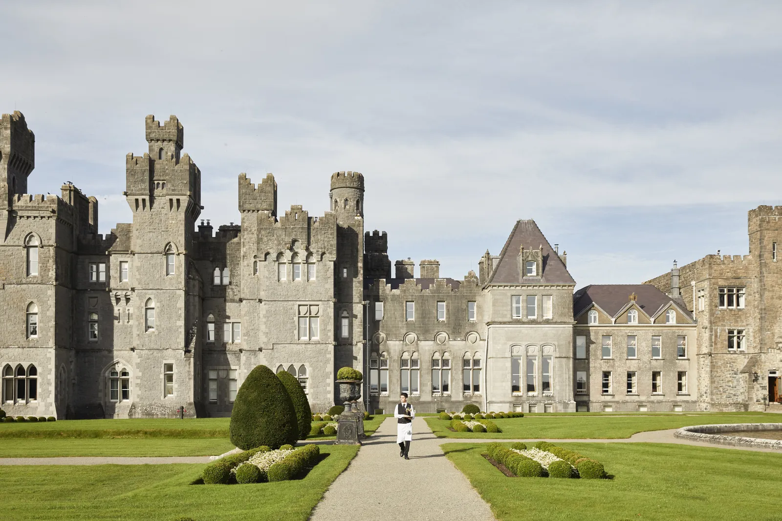 The castle’s battlemented towers beyond the lawns and the path