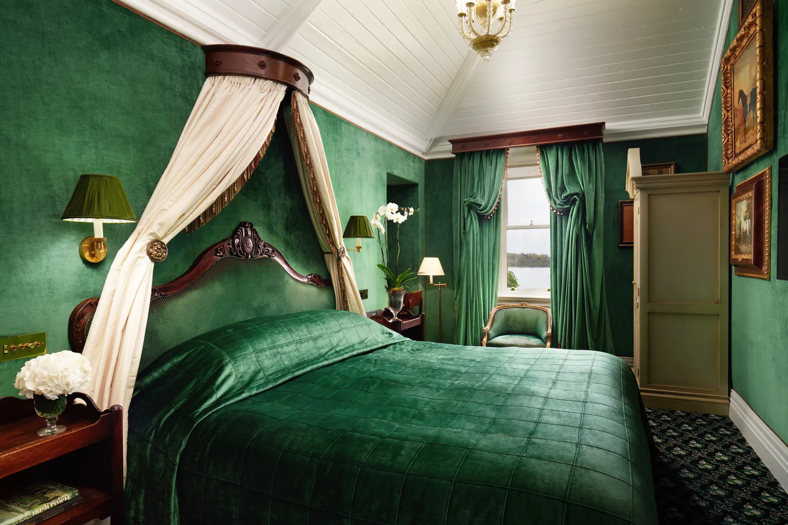 A Corrib Lake View Room: a green velvet canopy bed and windows over the lake