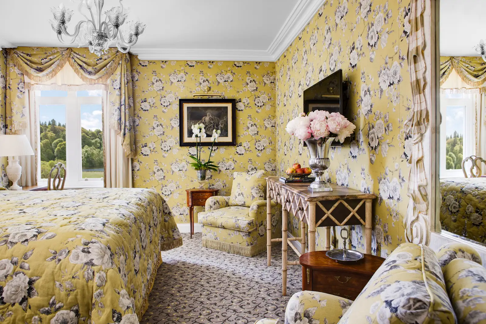 A Corrib Room: an upholstered bed, yellow wallpaper and a window onto the garden