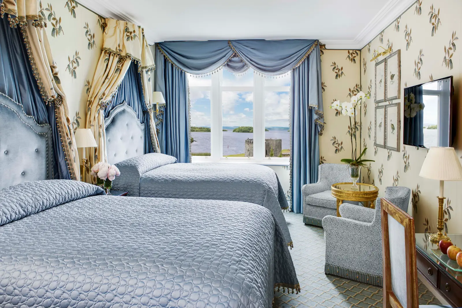 A Deluxe Queen Family Room: 2 queen beds and a sitting corner