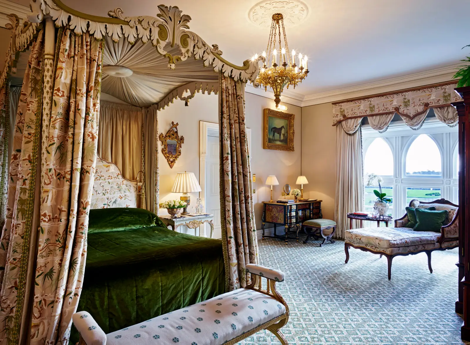 The Reagan Presidential Suite: a green velvet four-poster and a chandelier