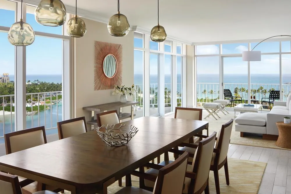 The dining and living room of the Governor Suite, glazed on 2 sides over the sea and the lagoon.