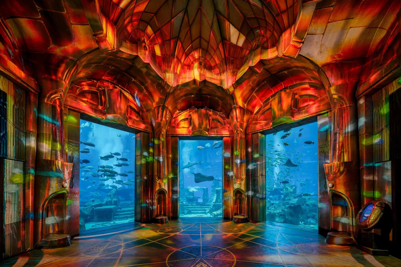The Lost Chambers gallery with aquarium windows under painted arches