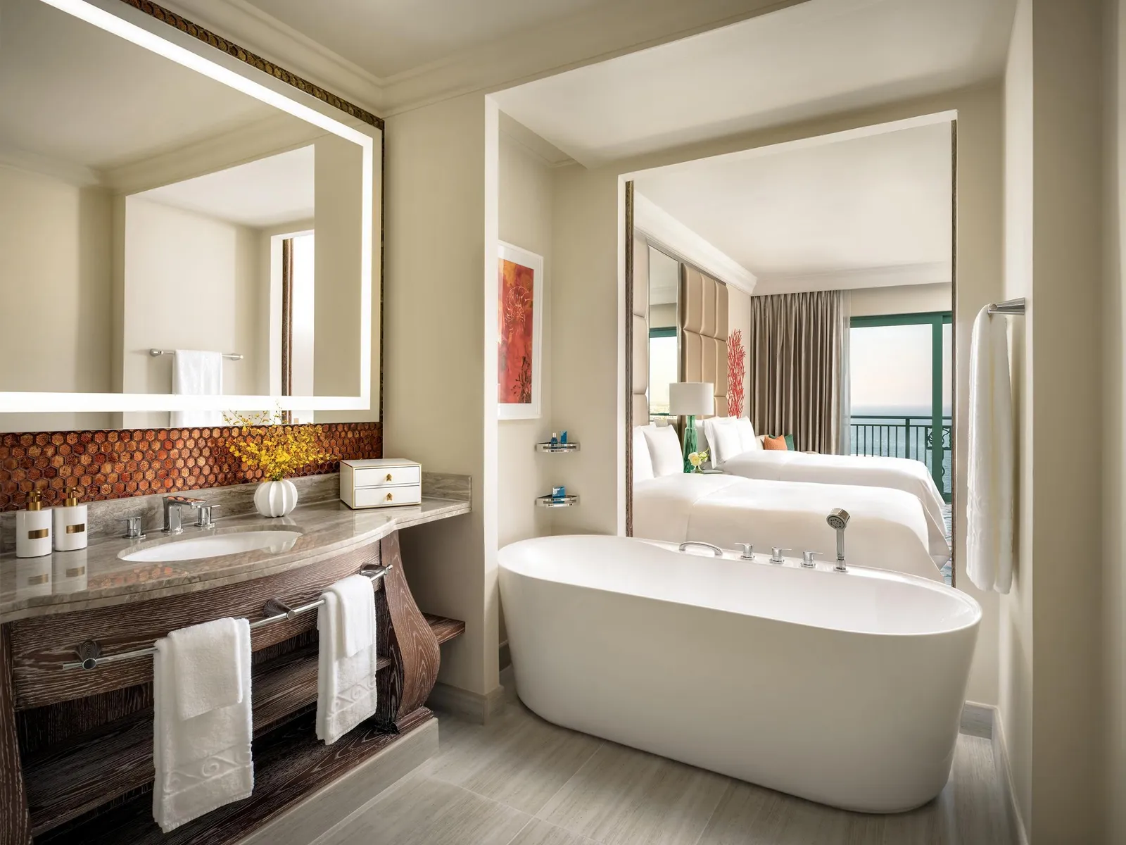 The bathroom with a freestanding bath and the Imperial Club room beyond the mirror