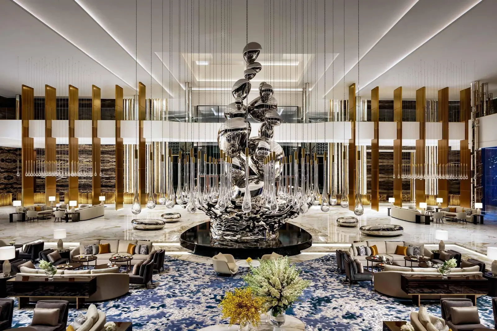 The lobby with its large silver sculpture under golden light