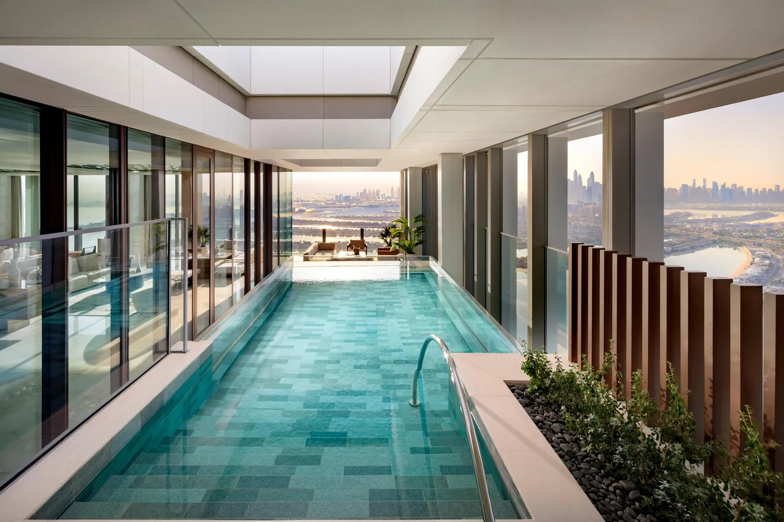 A penthouse’s indoor pool with a view of the city