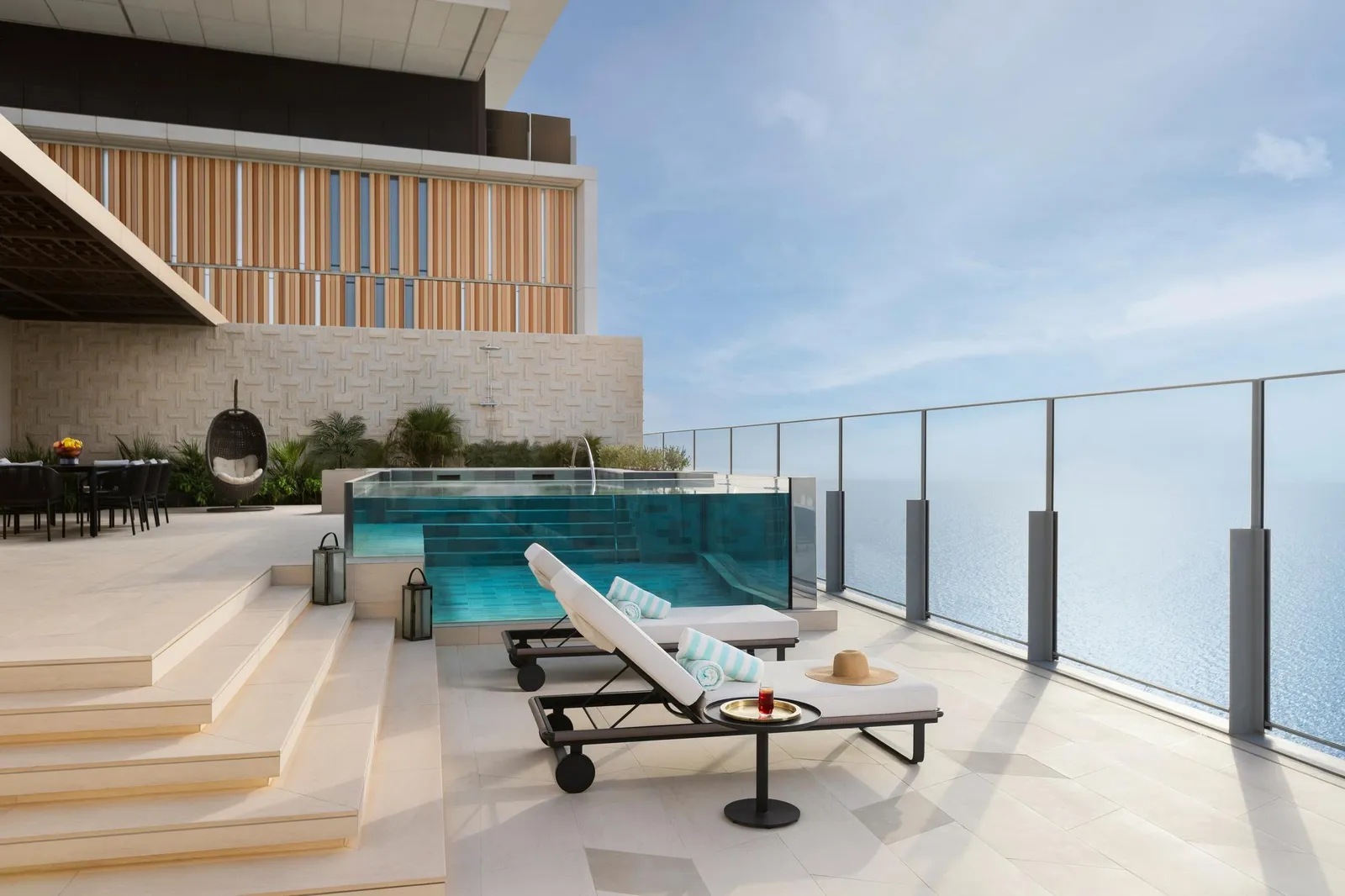 A penthouse terrace with loungers and a pool