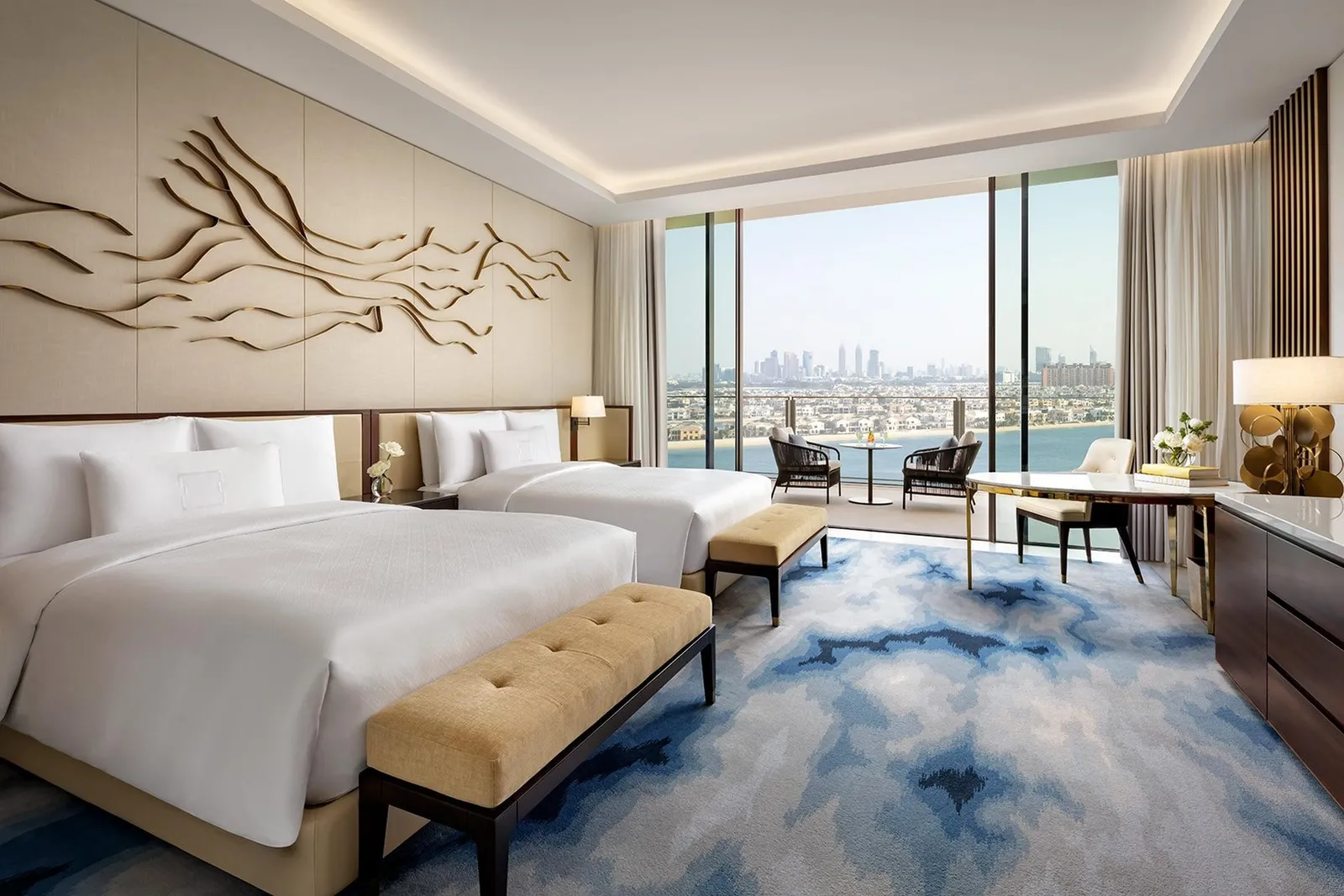 A room with 2 queen beds and the Palm beyond the glass