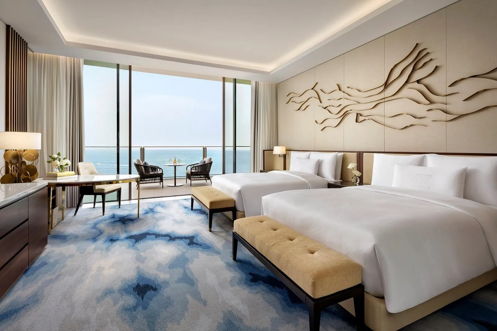 A room with 2 queen beds and a sea view