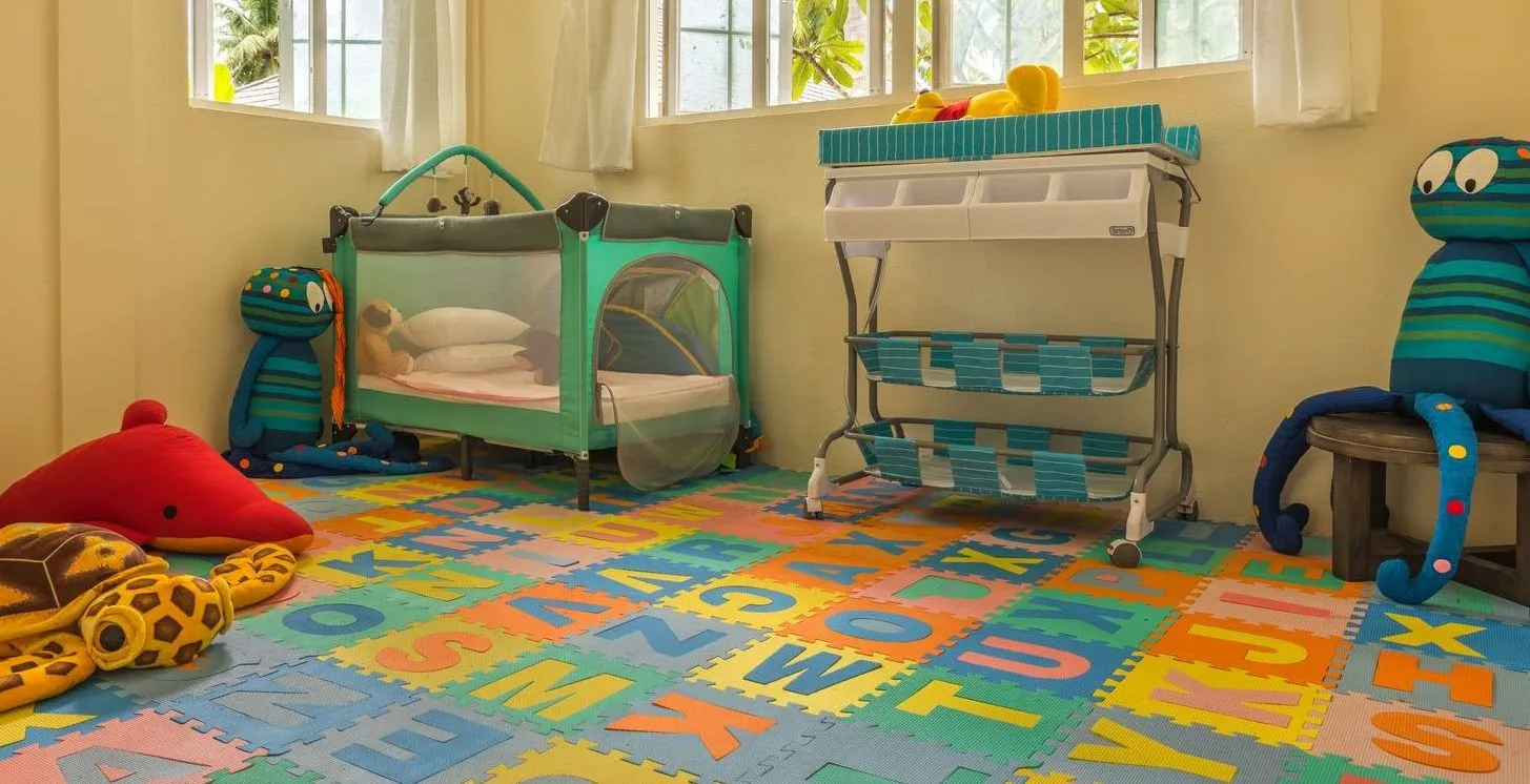 The kids’ club room: bright mats, toys and cots for the youngest