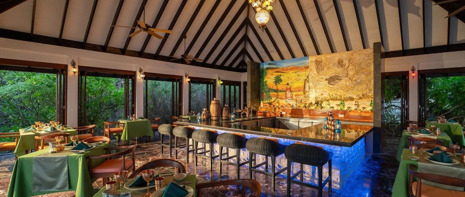 The interior with its blue-lit bar and the mural on the back wall