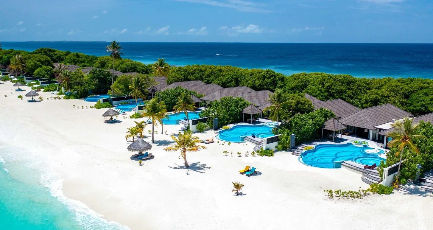 The Kanifushi Residences from the air, their pools along the beach