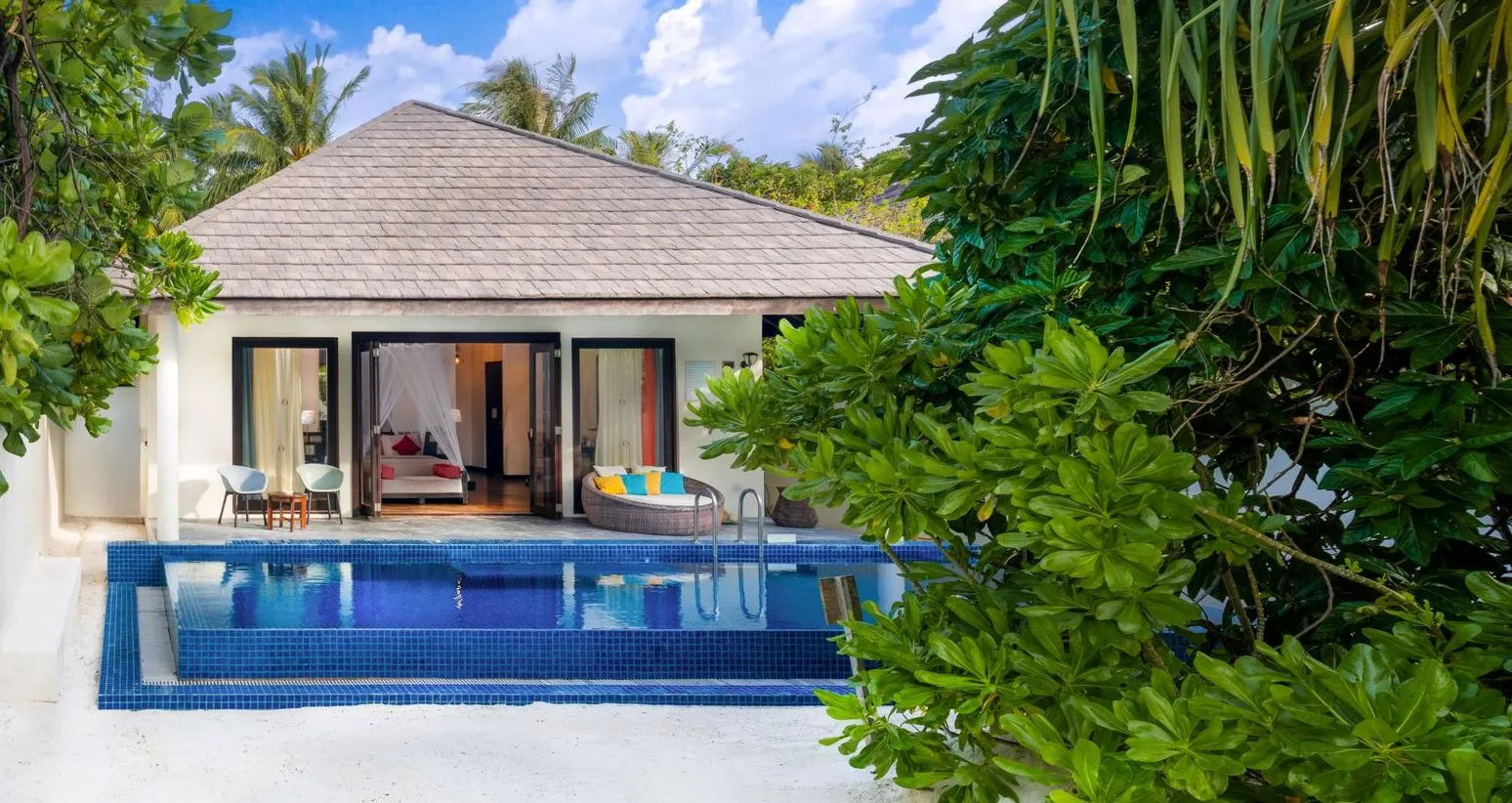 A Sunset Beach Villa with Pool: the pool in front of the villa, among the greenery