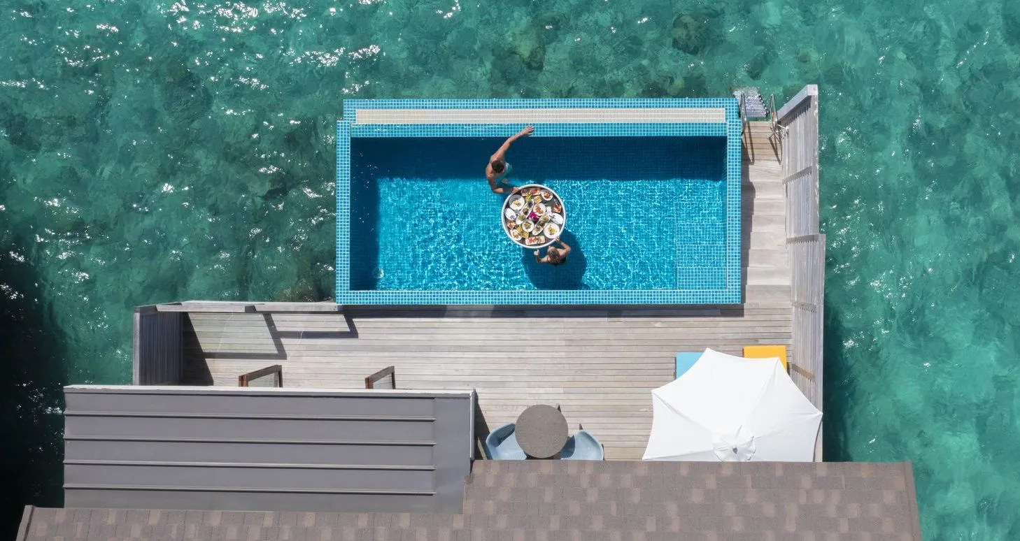 A Sunset Water Villa with Pool from above: the pool on its deck over the lagoon