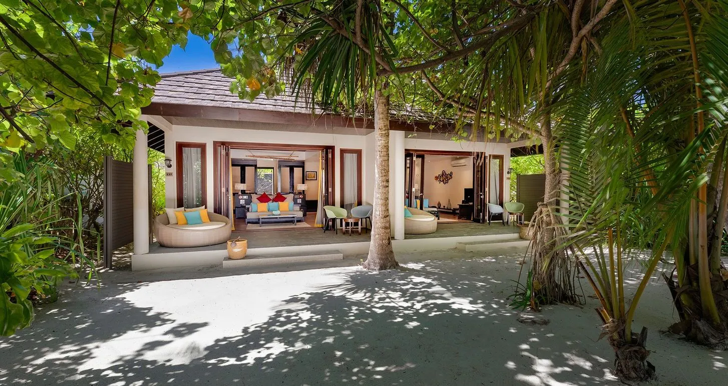 A Two Bedroom Sunset Family Beach Villa among the trees, its veranda on the sand