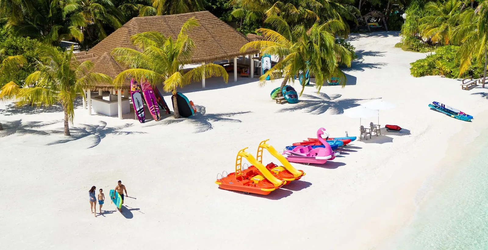 The water sports centre on the beach, bright pedalos and canoes