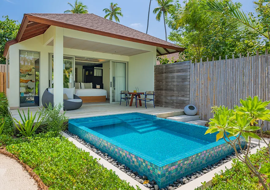 The Beach Pool Villa: the private pool in front of the bedroom, the timber fence and the garden.