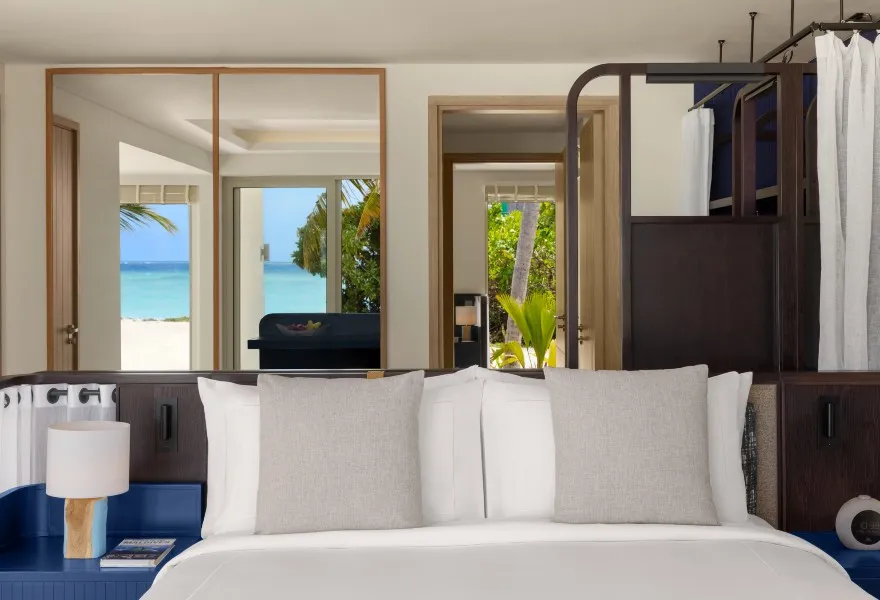 One bedroom of the 2-bedroom beach villa, its glass facing the sand.