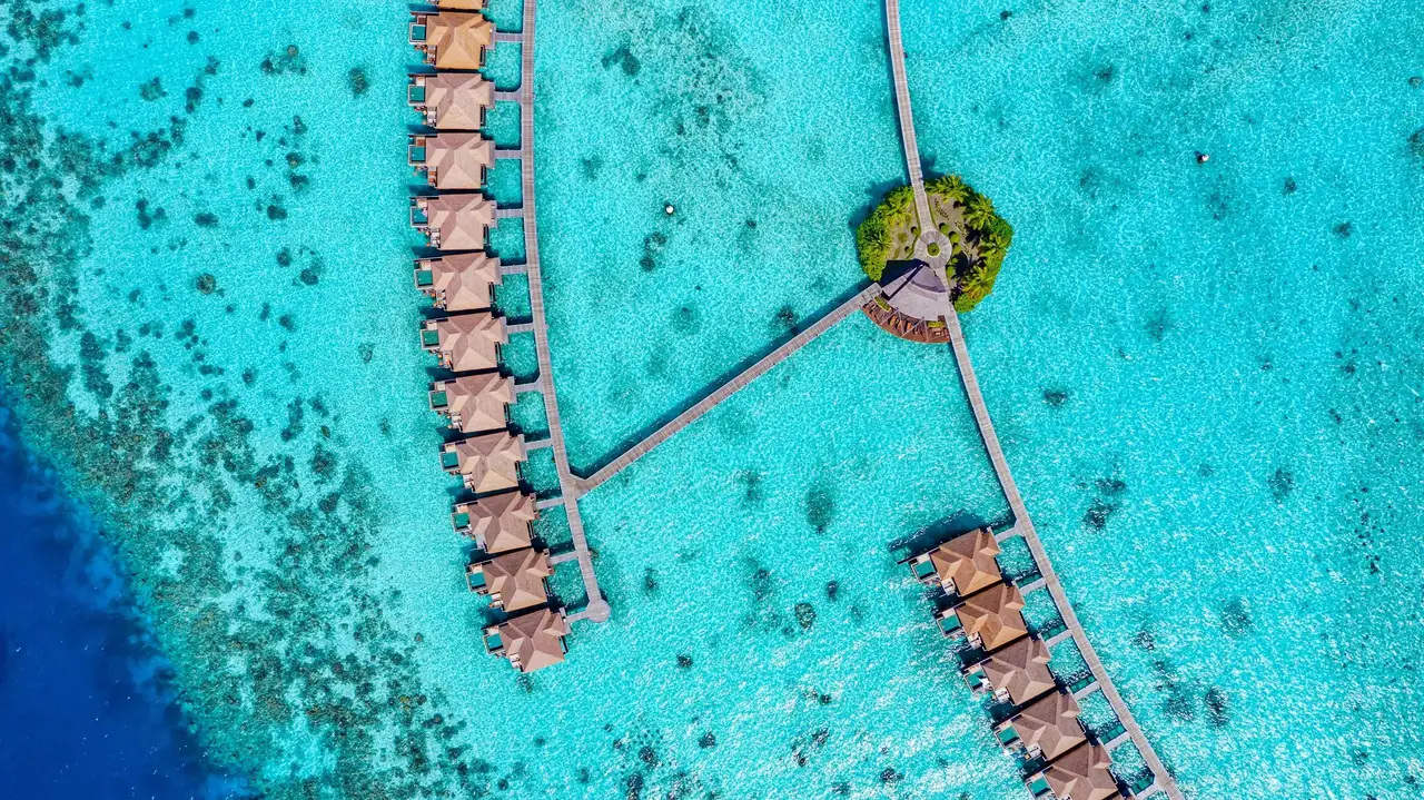 The walkways of the water villas from above, over the coral