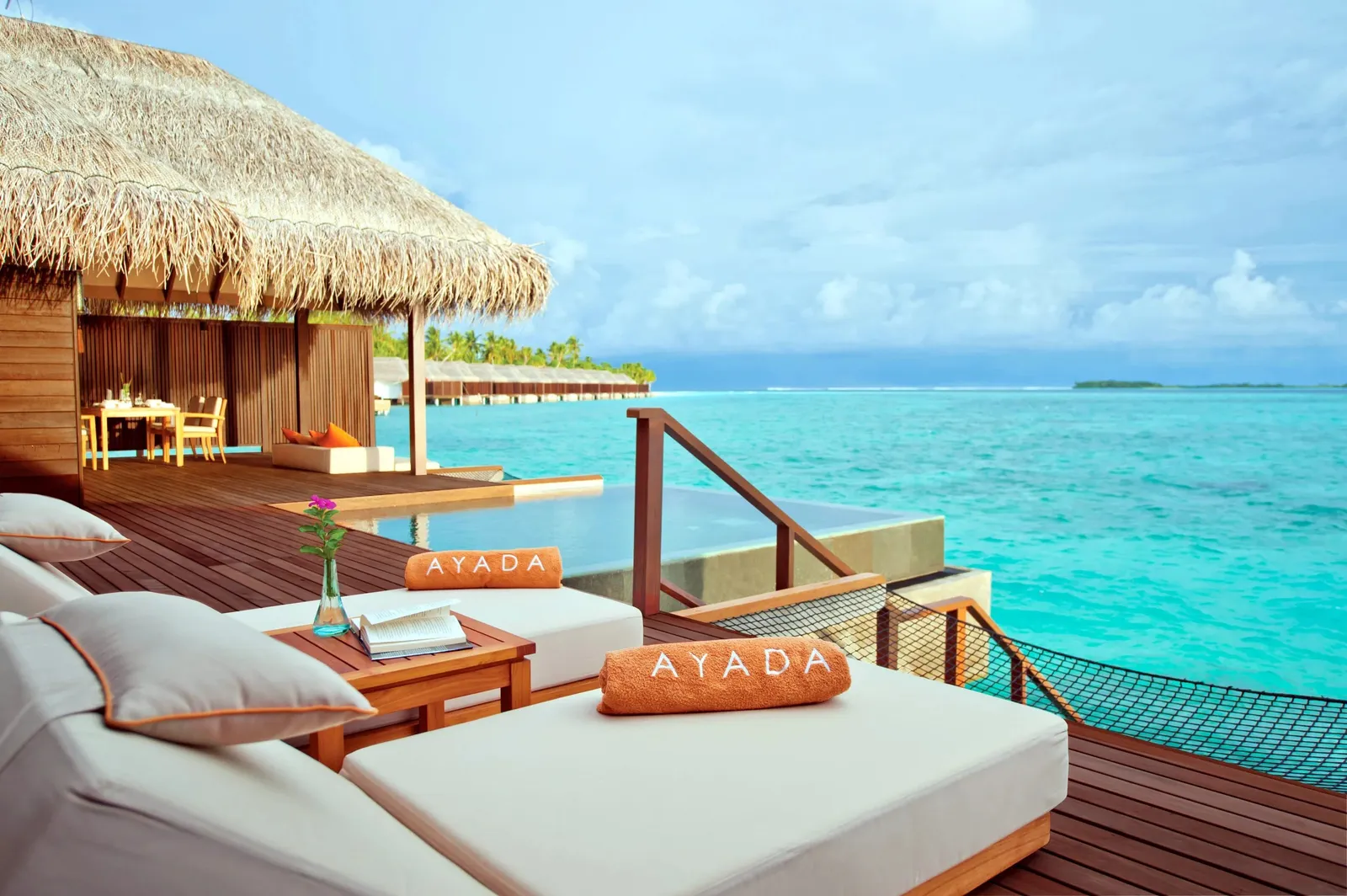 A Sunset Family Ocean Suite’s deck, its loungers and the net slung over the water