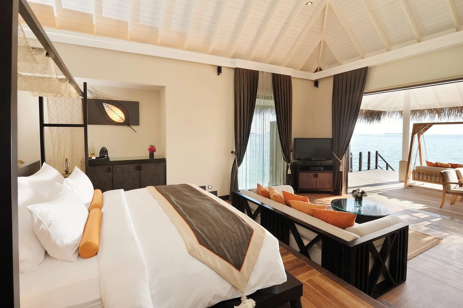 A Sunset Lagoon Suite bedroom, the bed facing the lagoon