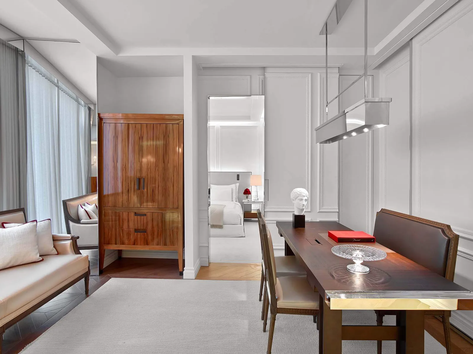 A desk, wooden wardrobe and opening into a Classic Suite bedroom