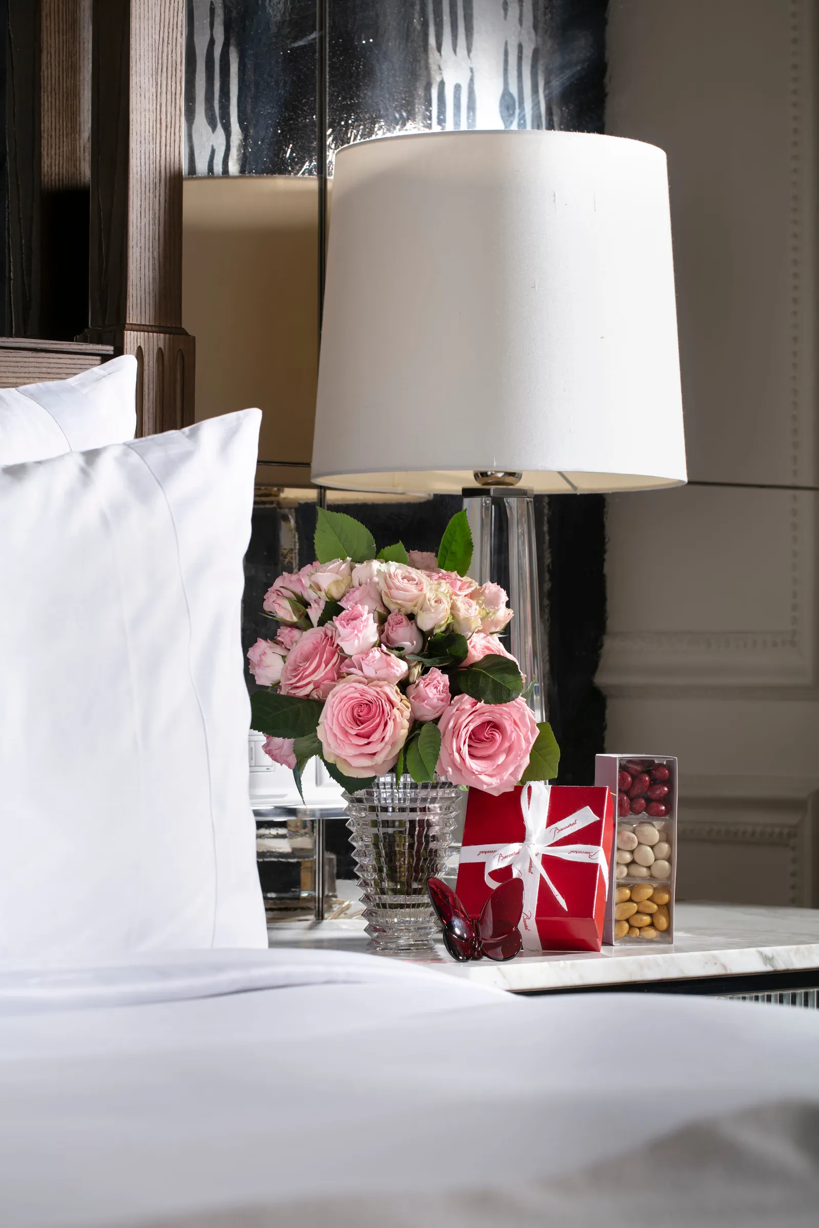 Flowers next to a table lamp