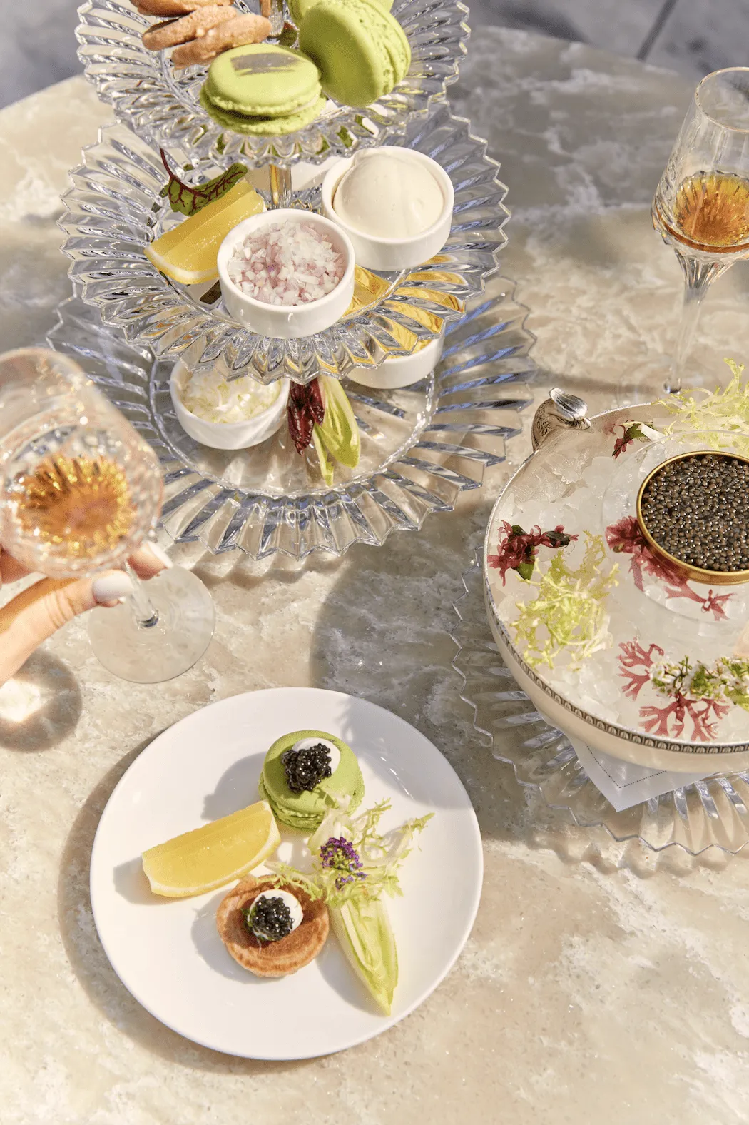Caviar, small plates and glasses on a table