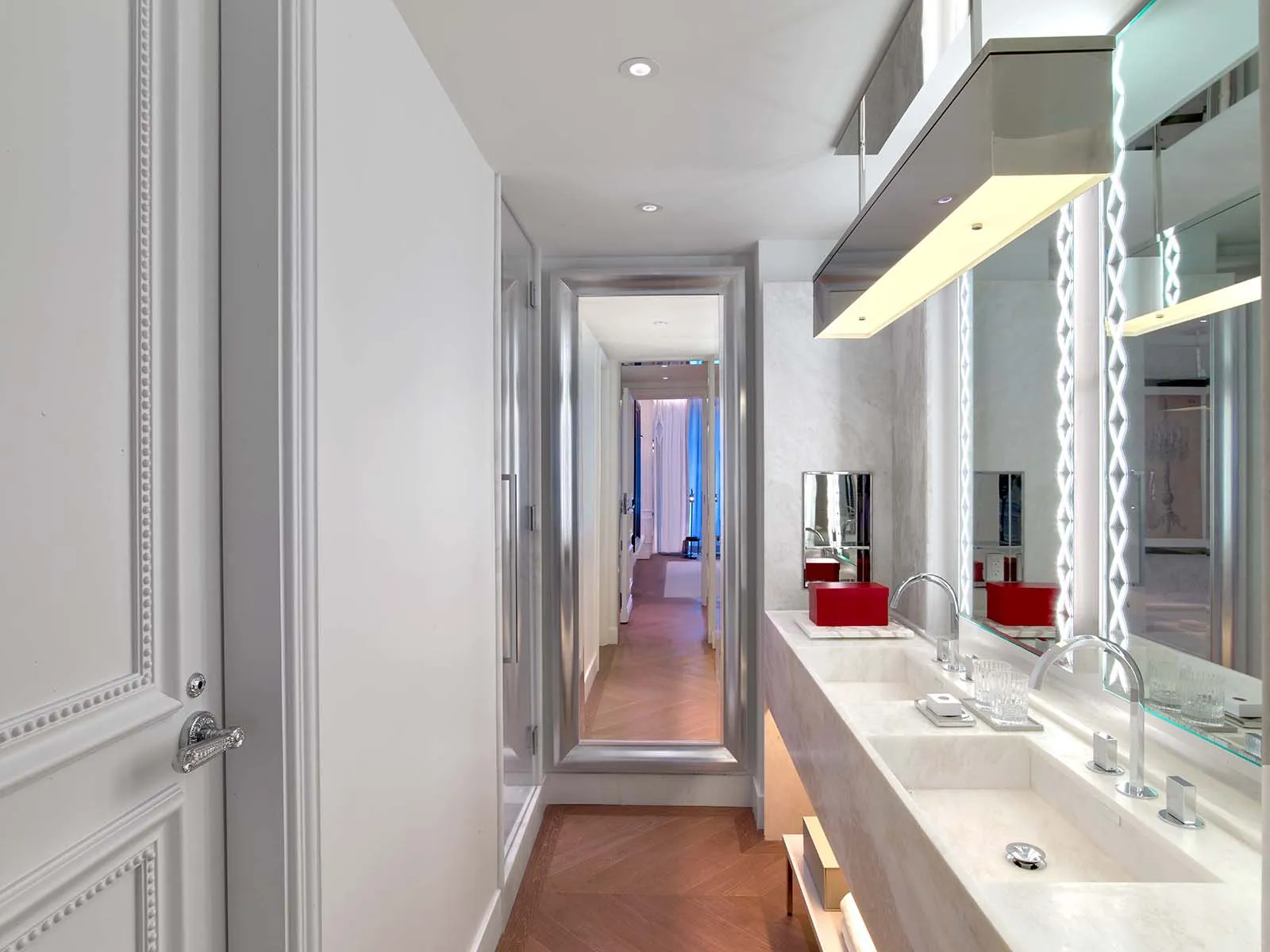 Double marble vanity and illuminated mirrors in the photograph published in the Harcourt One-Bedroom gallery