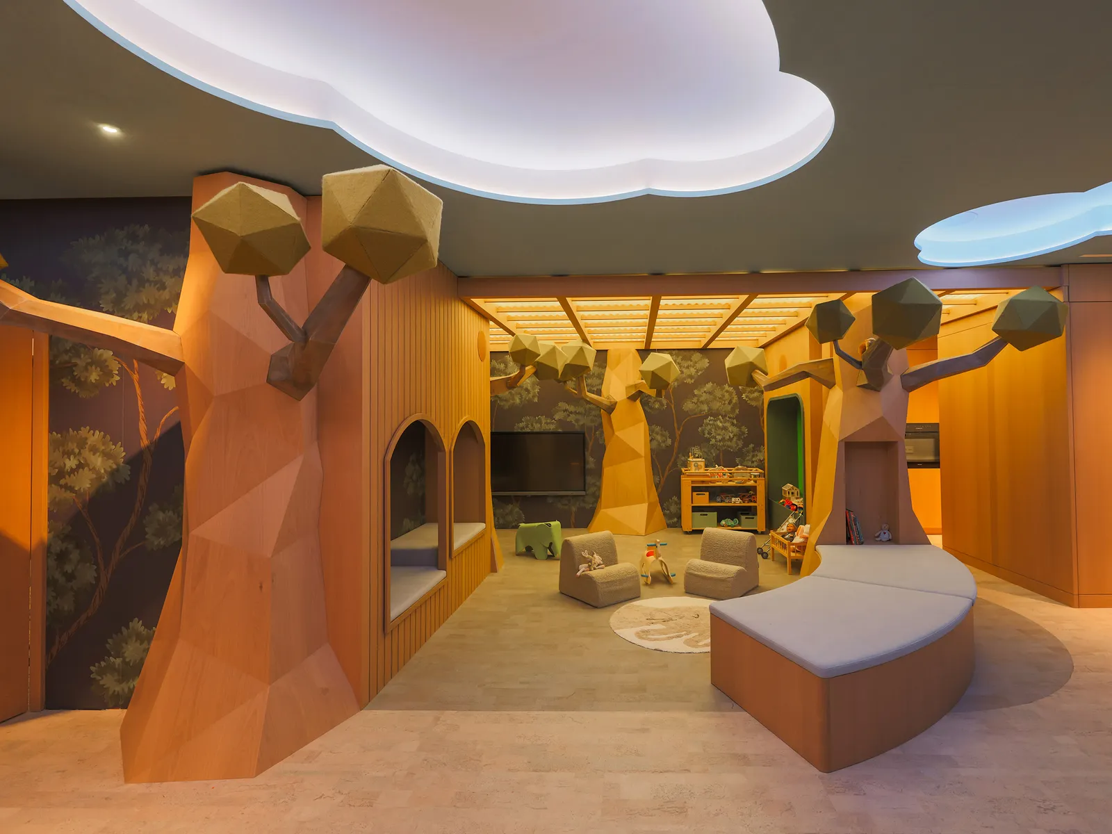 The Palazzino Kids Club: wooden trees with faceted crowns, a little house, a curved sofa and a ceiling of clouds.