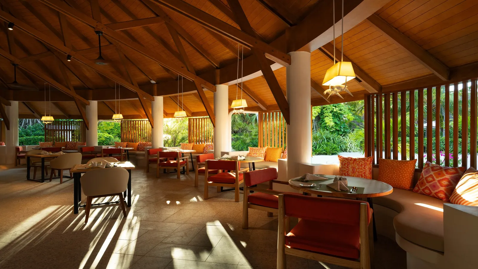 The renovated Gallery, orange seats beneath the wooden roof and light from the garden