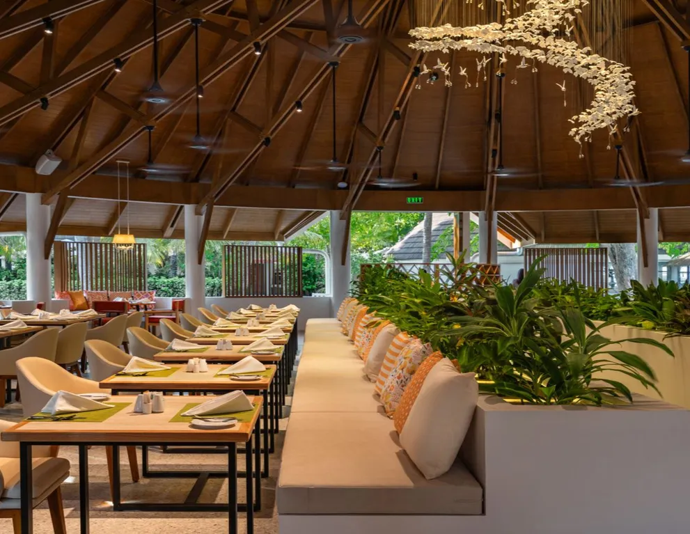 One of Gallery’s halls, its tables laid beneath the wooden roof and plants