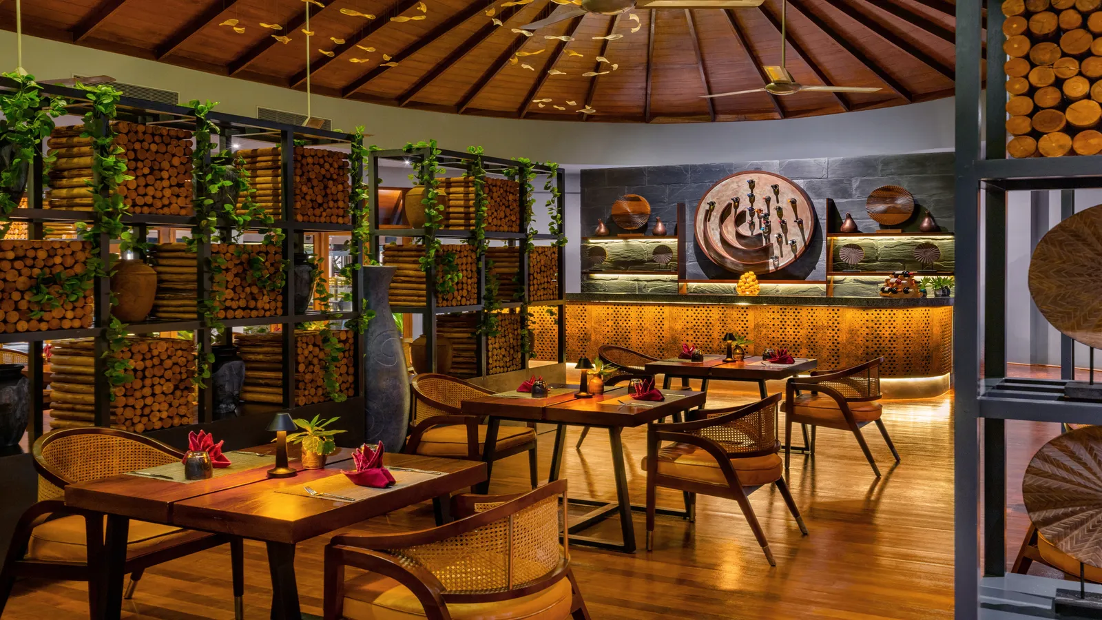 The Grill Bar’s dining room, wood, stacked logs and warm lights