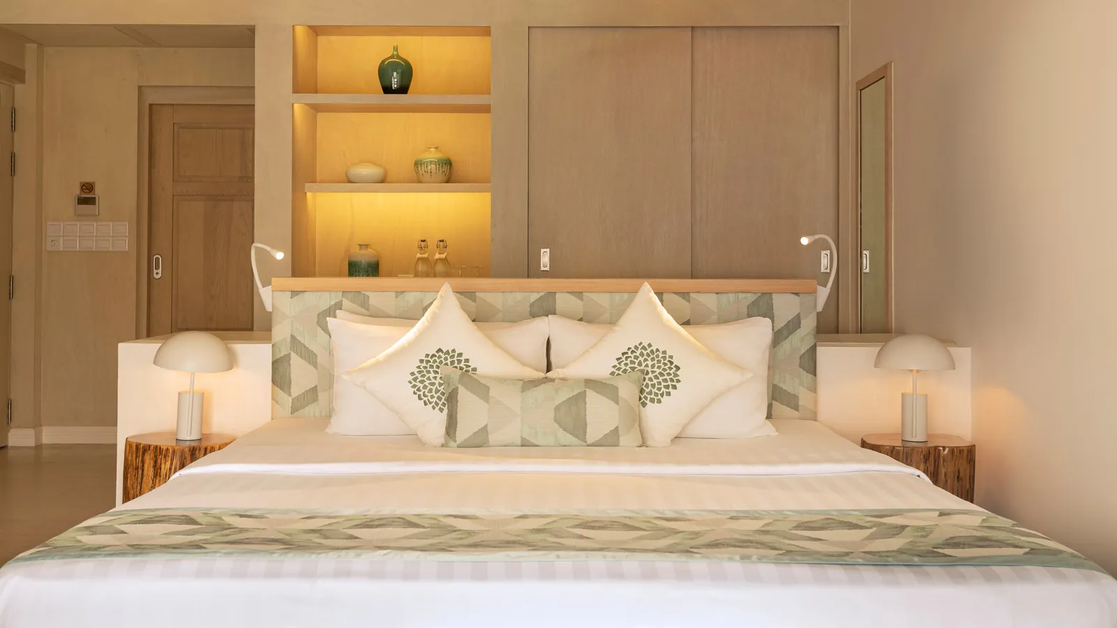 A Superior Villa bed between lit shelves