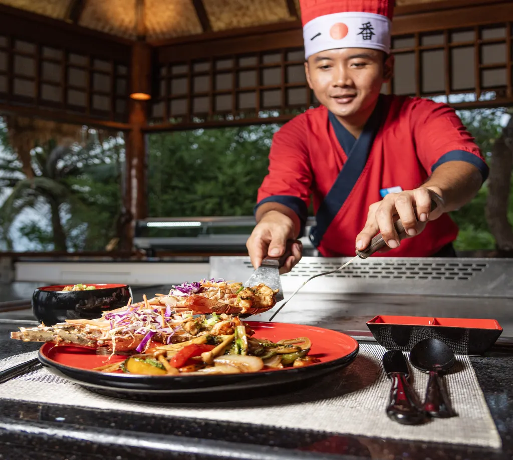 An Umi Yaki chef serving a dish from the teppanyaki grill