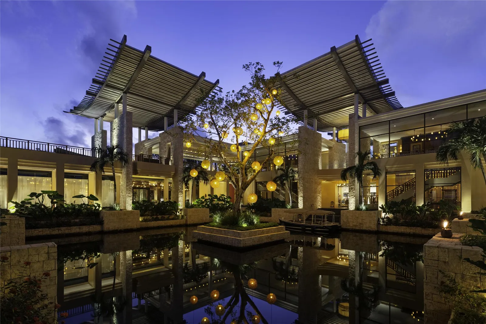 The lit lobby reflected in the water