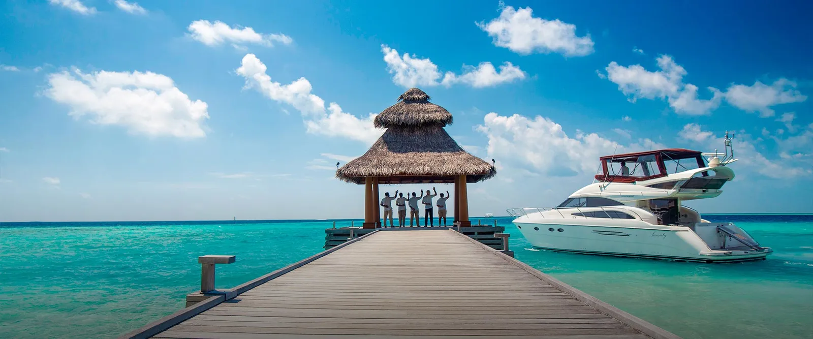 Baros’s jetty with its welcome pavilion and a yacht moored in the lagoon