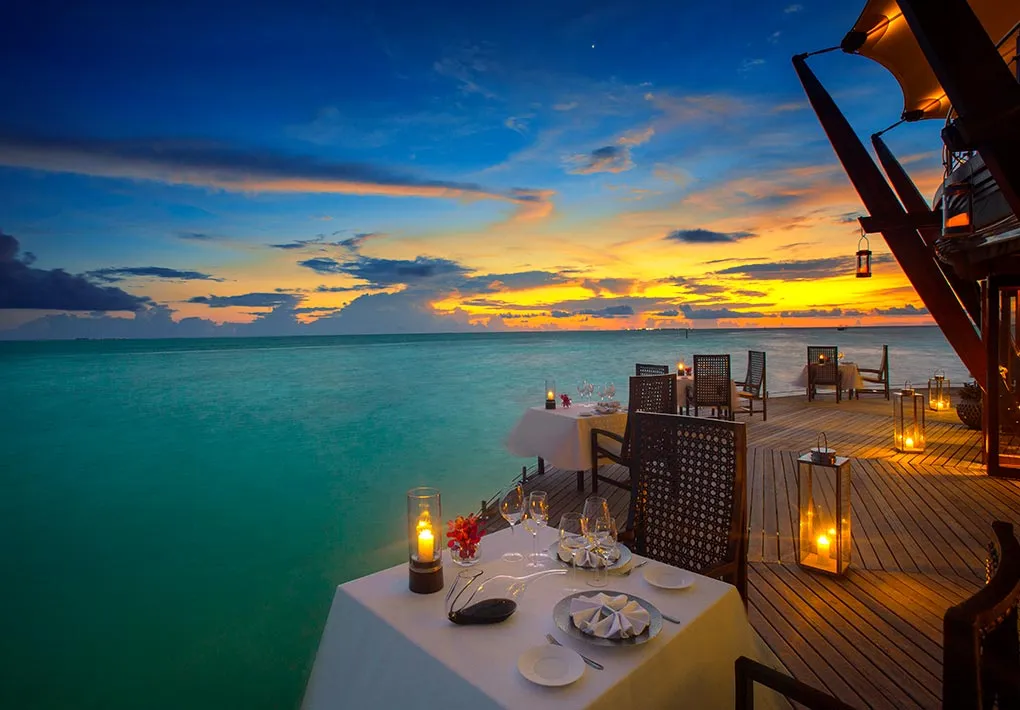 A table laid with a candle on the Lighthouse deck at sunset
