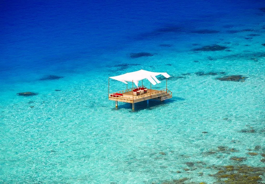 The Piano Deck under its white awning, alone in the middle of the lagoon