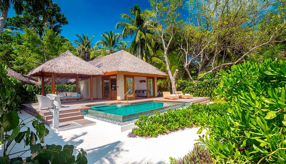 A Baros Suite among the palms, its pool in front of the villa