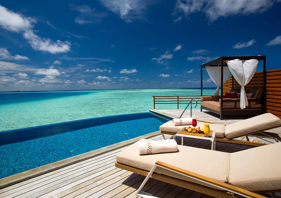 A Water Pool Villa’s infinity pool over the turquoise lagoon
